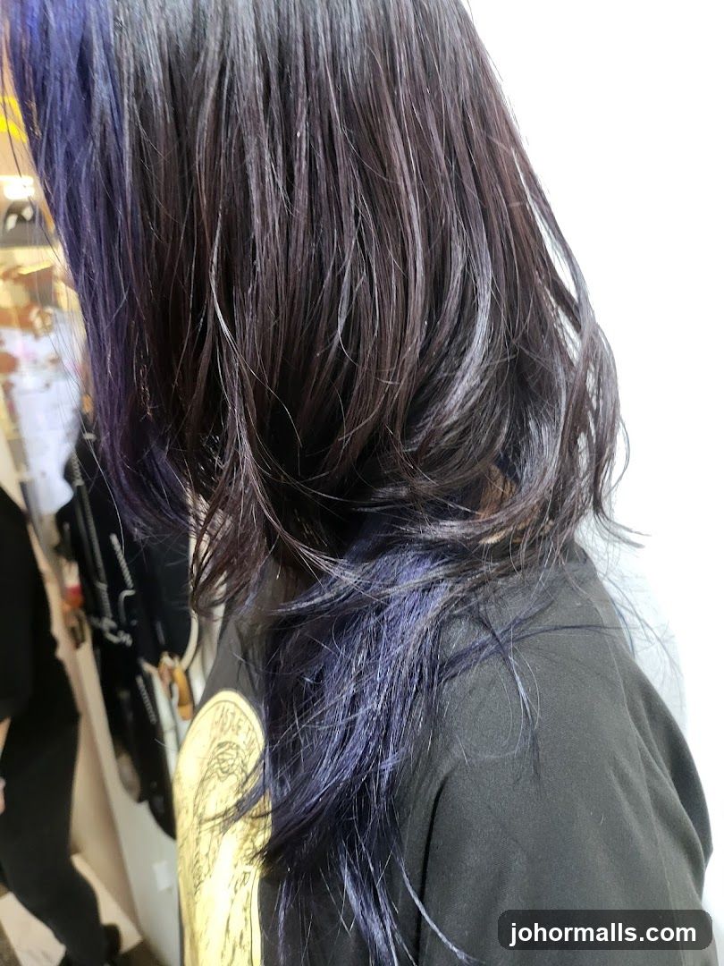 Woman with dark hair with purple highlights
