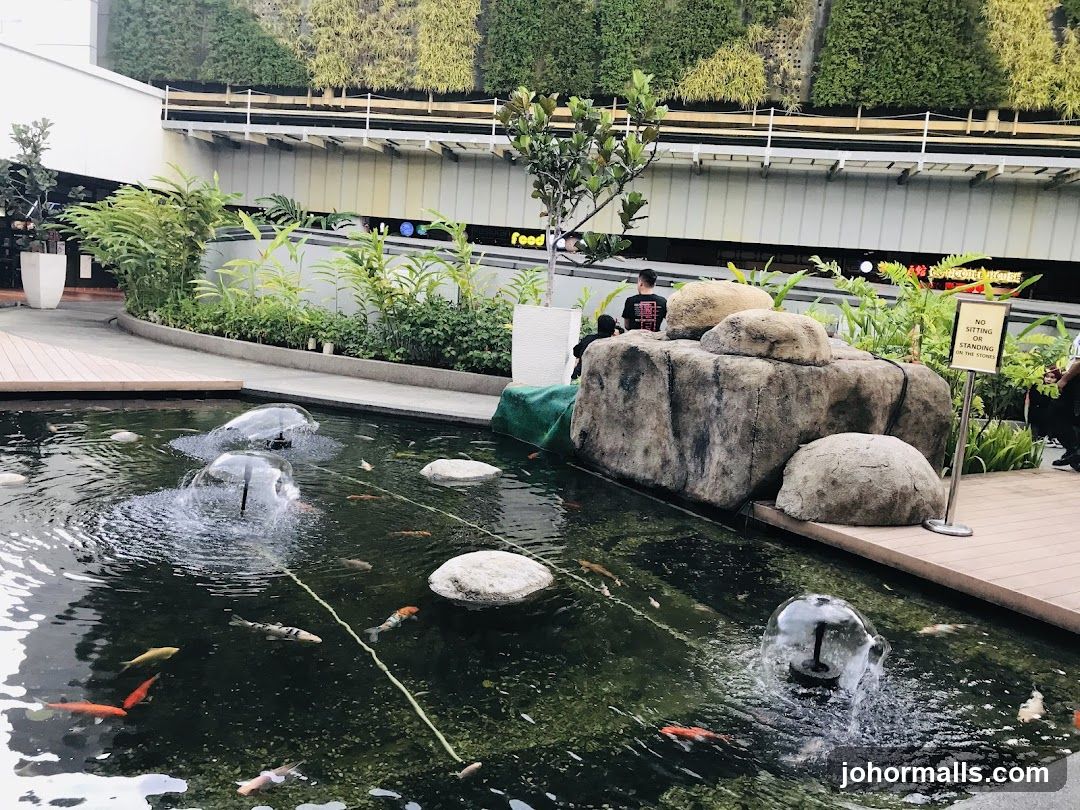 Outdoor Koi Pond with Fountains and Green Wall