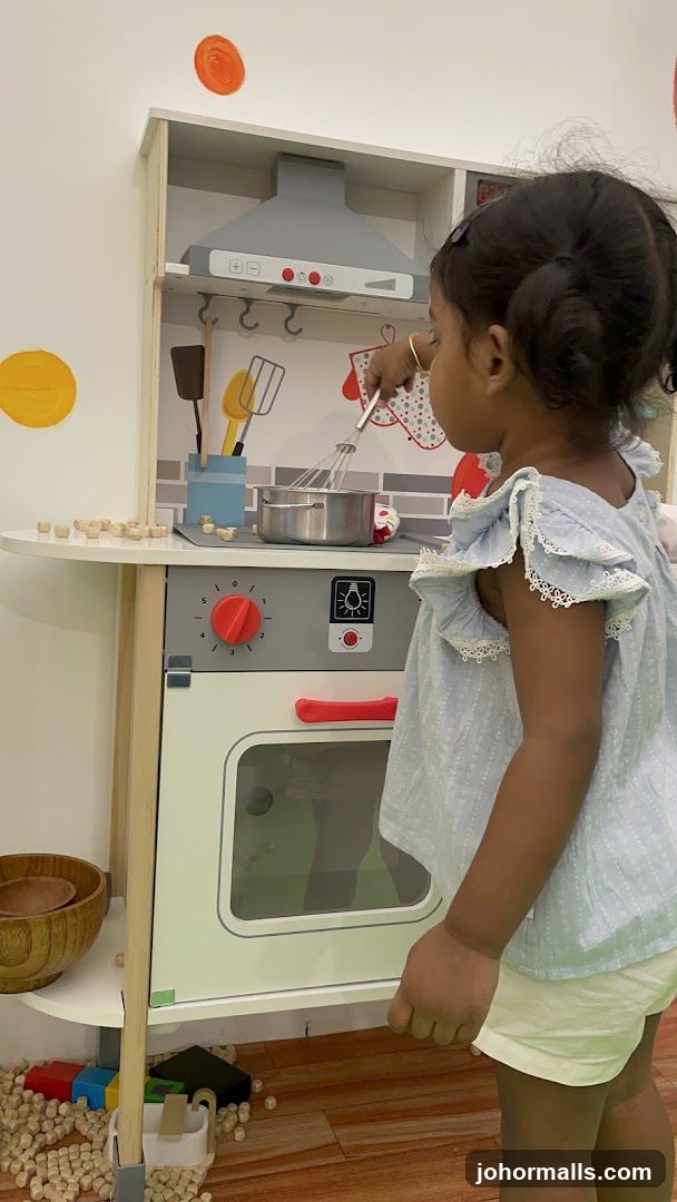 Child Playing with Toy Kitchen