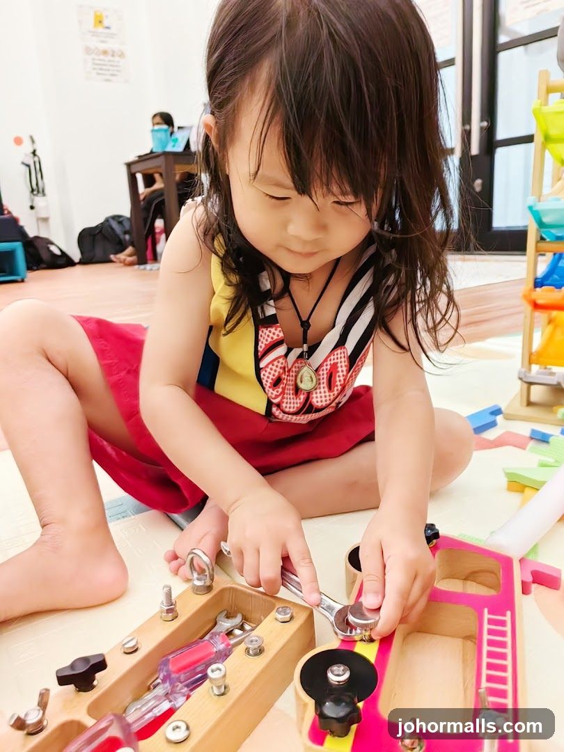 Child playing with a toy tool set