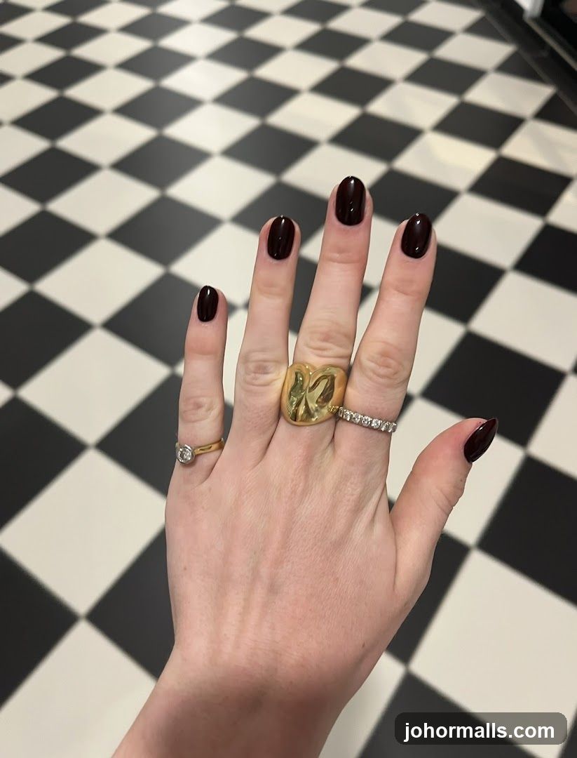 Hand with Dark Red Nails and Rings
