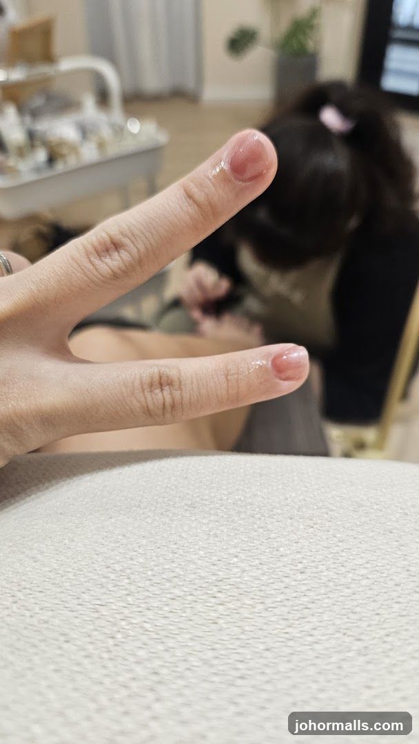 Person showing freshly manicured nails