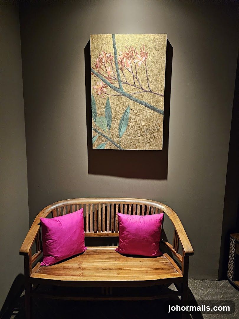 Wooden bench with pink cushions and artwork