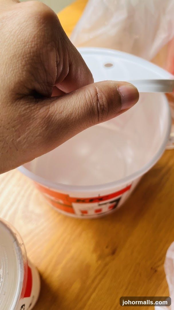 Hand holding a lid over a bowl